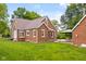 Backyard view of a brick home featuring a patio with an outdoor dining set at 2645 Washington St, Columbus, IN 47201