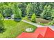 Picturesque home with a red roof, scenic pond, and a tranquil wooded surrounding at 2780 W Grizzly Trl, Martinsville, IN 46151