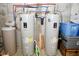 Basement area featuring dual water heaters with red and blue piping against concrete foundation walls at 2780 W Grizzly Trl, Martinsville, IN 46151