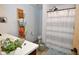 Bathroom with decorative shelf storage, a shower with a striped curtain, and modern fixtures at 2780 W Grizzly Trl, Martinsville, IN 46151
