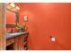 Charming bathroom featuring an ornate mirror and vanity with a dark countertop and flower accent at 2780 W Grizzly Trl, Martinsville, IN 46151