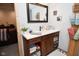 Bathroom vanity with a mirror, storage cabinets, and rustic decor at 2780 W Grizzly Trl, Martinsville, IN 46151