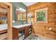 Bright bathroom boasts wood paneling, a window, and a modern sink and vanity at 2780 W Grizzly Trl, Martinsville, IN 46151