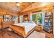 Spacious bedroom with wood paneled vaulted ceiling and a large window for natural light at 2780 W Grizzly Trl, Martinsville, IN 46151