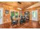 Cozy dining room with wood paneling, a wooden table set, and natural light from the window at 2780 W Grizzly Trl, Martinsville, IN 46151