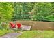 Beautiful pond with dock and two red Adirondack chairs perfect for relaxing and enjoying the scenery at 2780 W Grizzly Trl, Martinsville, IN 46151