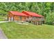 Stunning log home with a red metal roof, garage, and beautifully landscaped yard at 2780 W Grizzly Trl, Martinsville, IN 46151