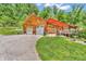 Charming log home featuring a red metal roof, two-car garage and welcoming deck perfect for enjoying the outdoors at 2780 W Grizzly Trl, Martinsville, IN 46151