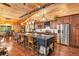 Charming kitchen featuring wood walls, stainless steel appliances, and a large island with seating at 2780 W Grizzly Trl, Martinsville, IN 46151