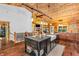 Open-concept kitchen with an island and view of the fireplace and living space at 2780 W Grizzly Trl, Martinsville, IN 46151