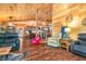Spacious living room showcasing hardwood floors, wood walls, and comfortable seating arrangement at 2780 W Grizzly Trl, Martinsville, IN 46151