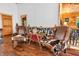 Cozy sitting area with comfortable seating, wood walls, and rustic railing at 2780 W Grizzly Trl, Martinsville, IN 46151