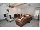 Relaxing living room featuring a leather sofa, accent chairs, and neutral decor at 2780 W Grizzly Trl, Martinsville, IN 46151