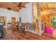 Open-concept living room with unique tree support, wooden walls, and rustic accents at 2780 W Grizzly Trl, Martinsville, IN 46151