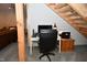 Functional home office space under an open staircase with a desk and office chair at 2780 W Grizzly Trl, Martinsville, IN 46151