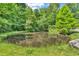 Scenic view of a tranquil pond surrounded by lush trees reflecting on the water's surface at 2780 W Grizzly Trl, Martinsville, IN 46151