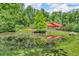 Scenic view of the house reflecting on the tranquil pond surrounded by lush trees at 2780 W Grizzly Trl, Martinsville, IN 46151