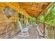 Inviting porch with rocking chairs, flowers, and rustic decor, perfect for relaxing outdoors at 2780 W Grizzly Trl, Martinsville, IN 46151