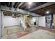 Unfinished basement with open ceiling, exposed ductwork, and stairs to the upper level at 2905 N Warman Ave, Indianapolis, IN 46222