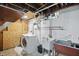 Basement laundry area with a washing machine, utility sink, and exposed piping at 2905 N Warman Ave, Indianapolis, IN 46222