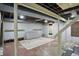 Unfinished basement with exposed ceiling, concrete flooring, shelving, and natural light at 2905 N Warman Ave, Indianapolis, IN 46222