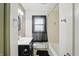 Neutrally decorated bathroom with window and vanity at 2905 N Warman Ave, Indianapolis, IN 46222
