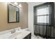 Well-lit bathroom with a stylish mirror and updated sink, complemented by a window with privacy sheers at 2905 N Warman Ave, Indianapolis, IN 46222