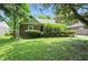 Traditional home boasts brick exterior with green trim and manicured shrubs at 2905 N Warman Ave, Indianapolis, IN 46222