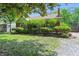 Landscaped front yard with brick exterior, shingle roof, and green trimmed house at 2905 N Warman Ave, Indianapolis, IN 46222
