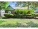 Charming brick bungalow featuring lush landscaping and inviting curb appeal at 2905 N Warman Ave, Indianapolis, IN 46222