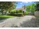 Brick home with long driveway, shingle roof, green trim and lush front landscape at 2905 N Warman Ave, Indianapolis, IN 46222
