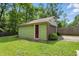 Exterior view of detached garage featuring a red door, gray siding and landscaping at 2905 N Warman Ave, Indianapolis, IN 46222