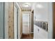 Charming hallway with unique palm tree-themed wallpaper and decorative trim, leading to another room at 2905 N Warman Ave, Indianapolis, IN 46222