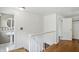 Second story hallway with hardwood floors connecting the bathroom to other rooms at 2905 N Warman Ave, Indianapolis, IN 46222