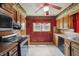 Traditional kitchen with oak cabinets, neutral countertops, stainless steel appliances, and red walls at 2905 N Warman Ave, Indianapolis, IN 46222