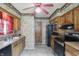 Traditional kitchen with oak cabinets, neutral countertops, stainless steel appliances, and unique wallpaper at 2905 N Warman Ave, Indianapolis, IN 46222