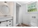 Bright bathroom with a shower, modern vanity with stylish drawers, and wood look floors at 301 S Main St, Whitestown, IN 46075