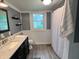 Well-lit bathroom featuring a marble countertop, sleek fixtures, and a charming window at 301 S Main St, Whitestown, IN 46075
