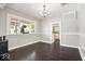 Bright dining room with dark wood floors and plenty of natural light, perfect for Gathering meals at 301 S Main St, Whitestown, IN 46075