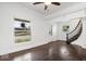 Inviting entryway with dark hardwood floors, staircase, and bright natural light at 301 S Main St, Whitestown, IN 46075