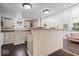 Charming kitchen with light wood cabinets, a central island, and a sink overlooking the backyard at 301 S Main St, Whitestown, IN 46075