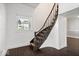 Elegant staircase with dark wood, paired with bright white walls creating a classic touch at 301 S Main St, Whitestown, IN 46075