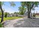 Landscaped yard with gravel area and mature trees surrounds this charming home's exterior at 301 S Main St, Whitestown, IN 46075
