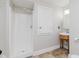 Bright bathroom with updated shower, a wood vanity, a custom sink, and tiled flooring at 3035 N Capitol Ave, Indianapolis, IN 46208