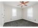 This bedroom features neutral walls, a ceiling fan, gray carpet and natural light from two windows at 3035 N Capitol Ave, Indianapolis, IN 46208