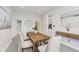 Bright dining room featuring a wooden table, modern light fixtures, and neutral paint, creating an inviting atmosphere at 3035 N Capitol Ave, Indianapolis, IN 46208
