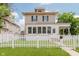 Charming two-story home featuring a white picket fence and well-maintained lawn at 3035 N Capitol Ave, Indianapolis, IN 46208