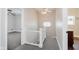 Hallway featuring modern railing, neutral paint, and ample natural light creating an inviting entryway at 3035 N Capitol Ave, Indianapolis, IN 46208