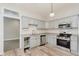 Corner kitchen showing stainless steel appliances, light gray cabinets, and wood floors creating a bright space at 3035 N Capitol Ave, Indianapolis, IN 46208