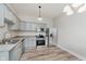 Well-lit kitchen with stainless steel appliances, light gray cabinets, and wood floors for a modern look at 3035 N Capitol Ave, Indianapolis, IN 46208
